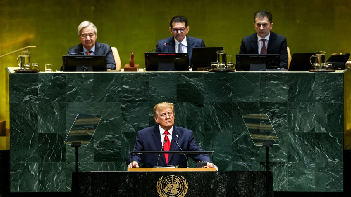 Donald Trump speaks from the UN General Assembly podium, with UN Secretary-General Guterres seated behind him.