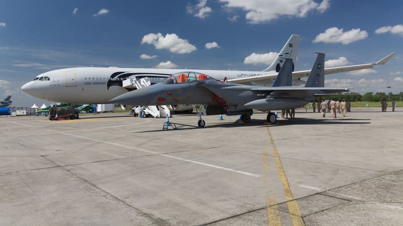 Royal Saudi Air Force F-15SA fighter parked in front of an Airbus A330 MRTT tanker at an air show