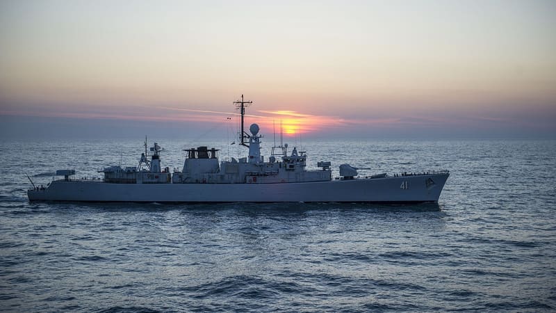 A grey Bulgarian Navy frigate with hull number 41 sails across the Black Sea with the sun low on the horizon.