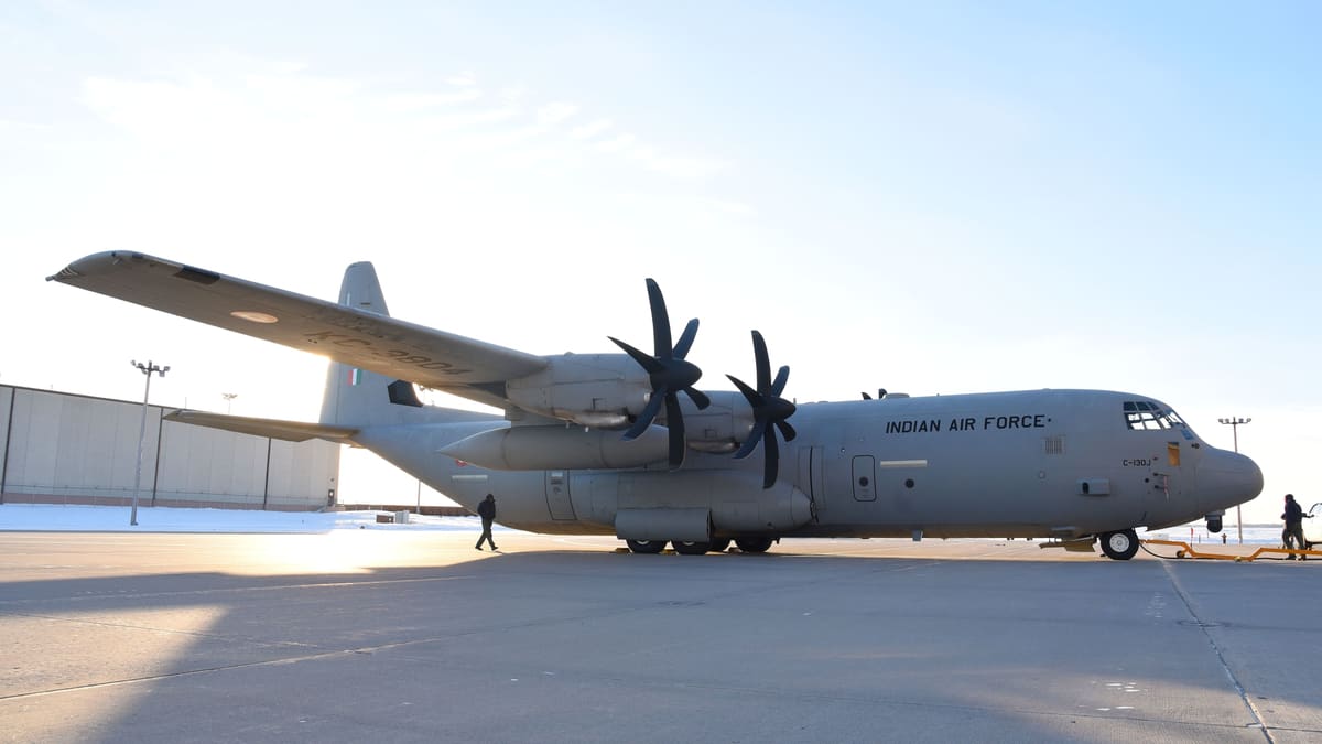 Indian Air Force C-130J Super Hercules transport aircraft parked on a snowy ramp at Grand Forks Air Force Base