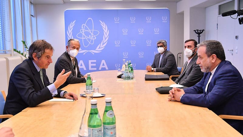 Abbas Araghchi seated at a table opposite IAEA chief Rafael Grossi in front of an IAEA backdrop, 2021 file photo