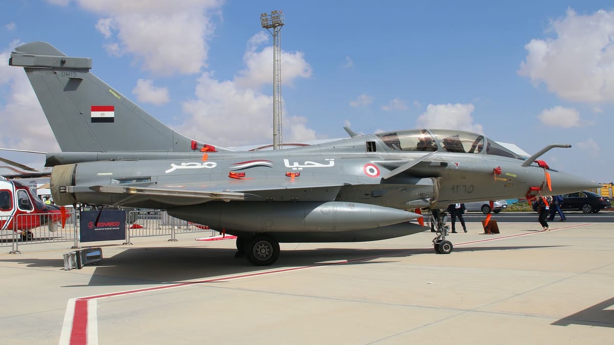 Grey two-seat Egyptian Air Force Rafale with the Egyptian flag on its tail, on static display at an airshow under a blue sky