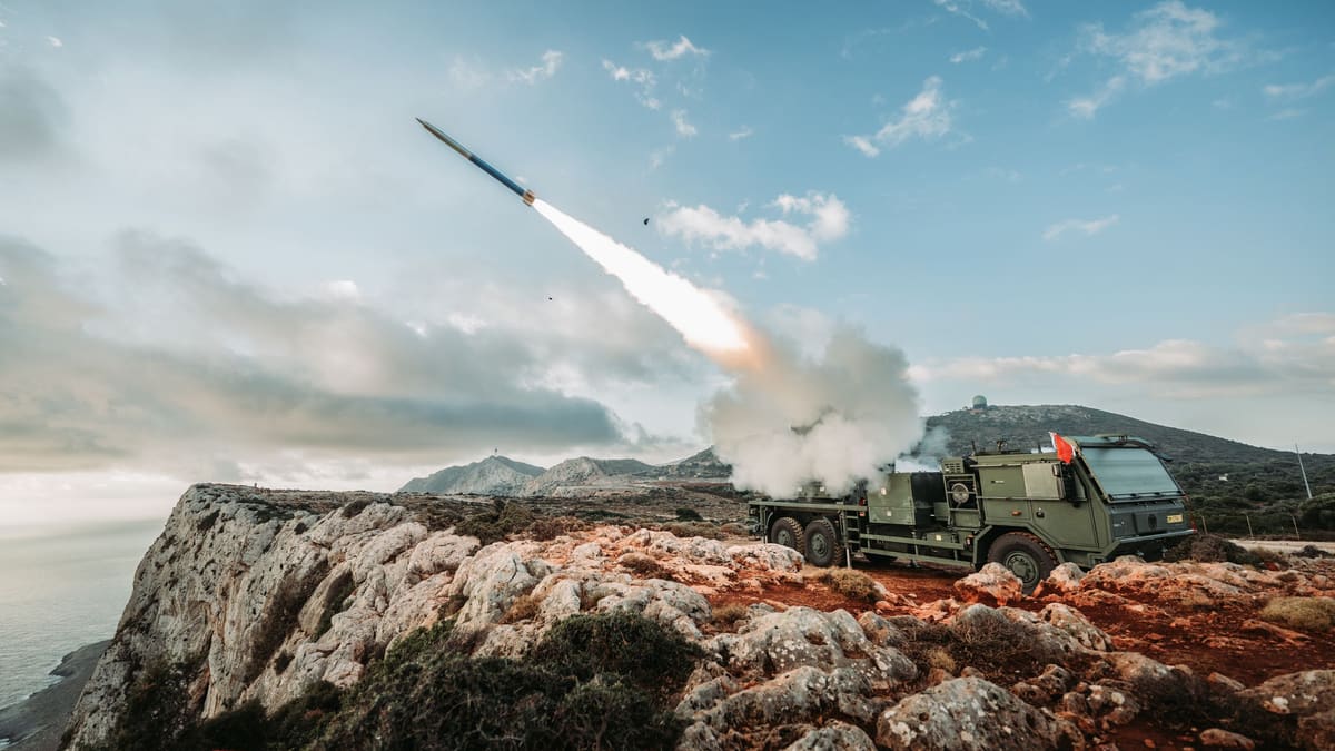 A rocket climbs away from a Dutch PULS launcher parked on a clifftop above the sea on Crete
