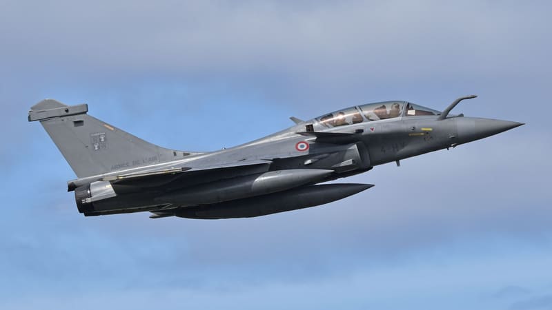 French Air Force Dassault Rafale B two-seat fighter climbing away with drop tanks under a cloudy sky