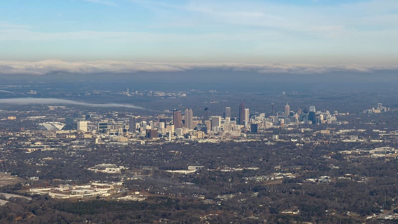 Aerial view of the downtown Atlanta skyline under a bank of cloud