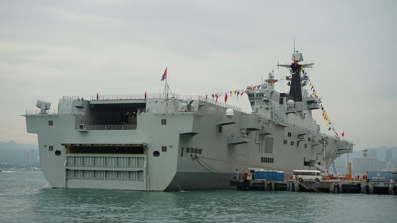 Grey Chinese amphibious assault ship Hainan berthed in Hong Kong, seen from the starboard stern with its well deck doors