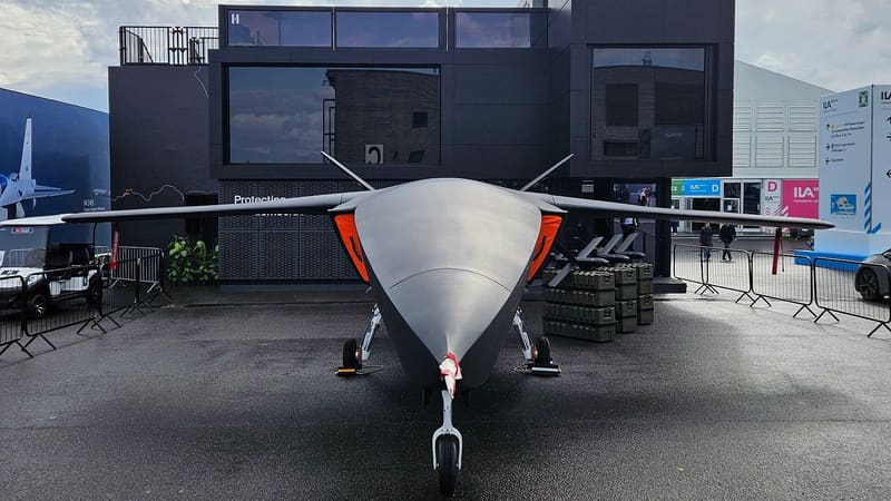 Dark grey Helsing CA-1 Europa drone mock-up seen head-on outside Helsing's ILA Berlin stand, HX-2 drones on crates