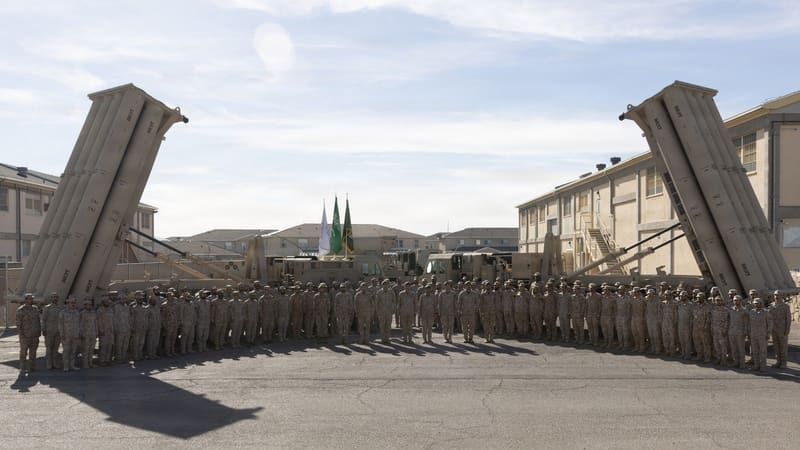 Saudi air defence soldiers stand in formation between two raised THAAD missile launchers