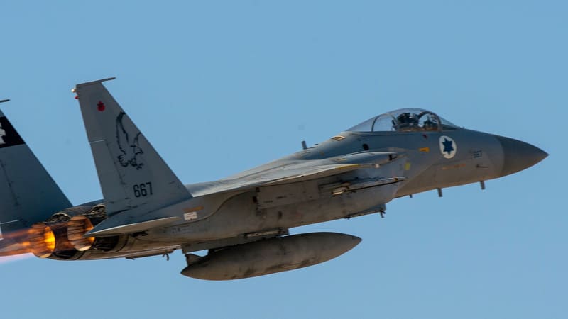 Israeli Air Force F-15 fighter, tail number 667, climbing in afterburner against a clear blue sky