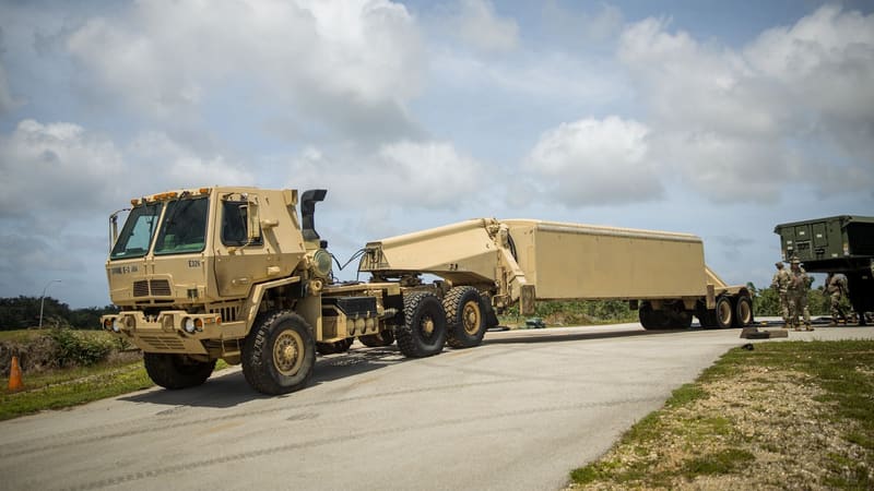 A U.S. Army truck tows a THAAD AN/TPY-2 radar, stowed for travel on its trailer, along a road on Guam