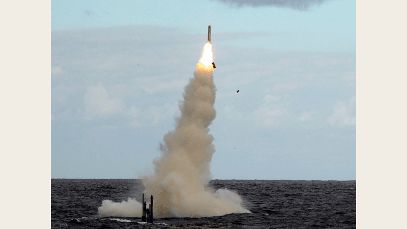 A Tomahawk cruise missile climbs on a column of smoke after launch from Royal Navy submarine HMS Astute
