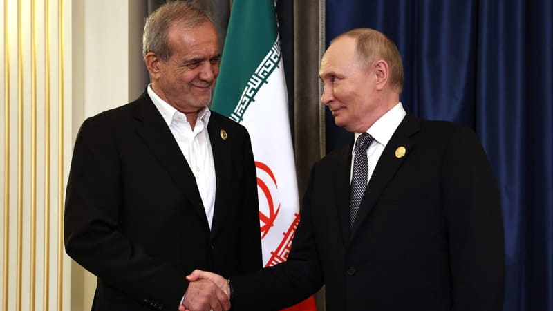 Iranian President Masoud Pezeshkian shakes hands with Russian President Vladimir Putin in front of an Iranian flag