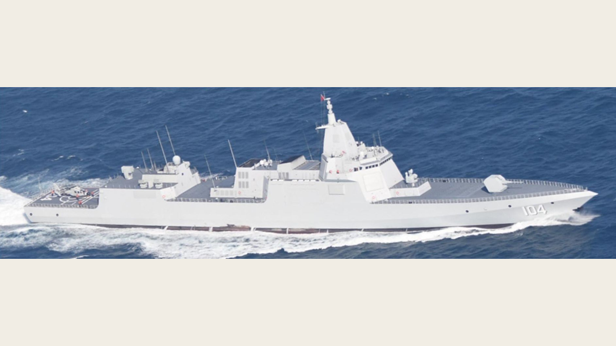 Chinese Type 055 destroyer Wuxi, hull number 104, at speed with a helicopter on its rear flight deck