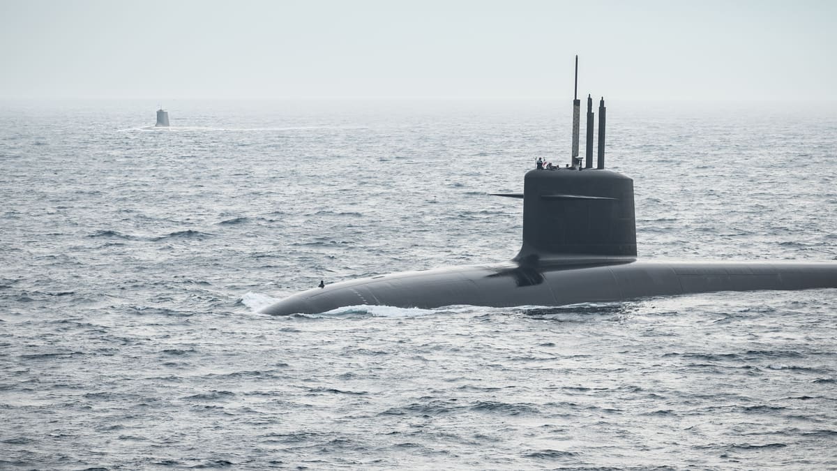 A French Le Triomphant-class ballistic-missile submarine surfaced at sea off Brest, a second submarine on the horizon