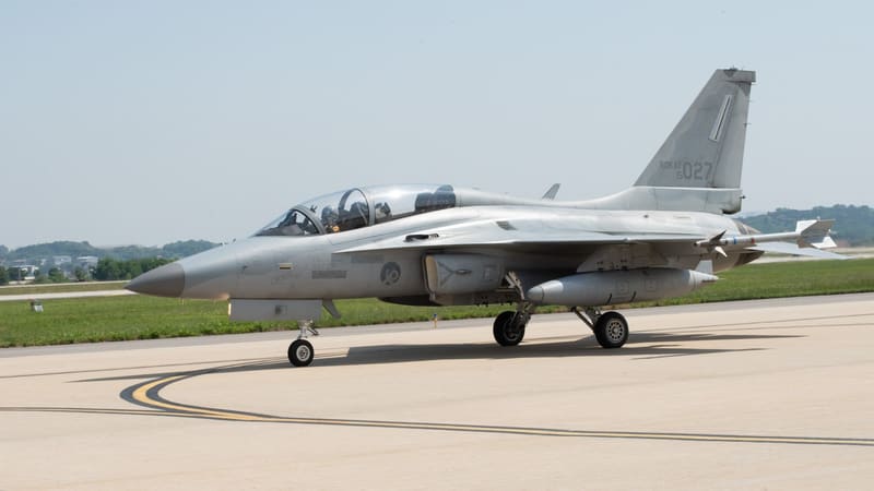 FA-50 light combat jet of the 202nd Fighter Squadron with a centreline fuel tank taxiing on a runway