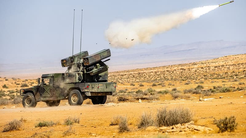 U.S. Army Avenger air defence vehicle on a Humvee firing a Stinger missile over desert scrubland