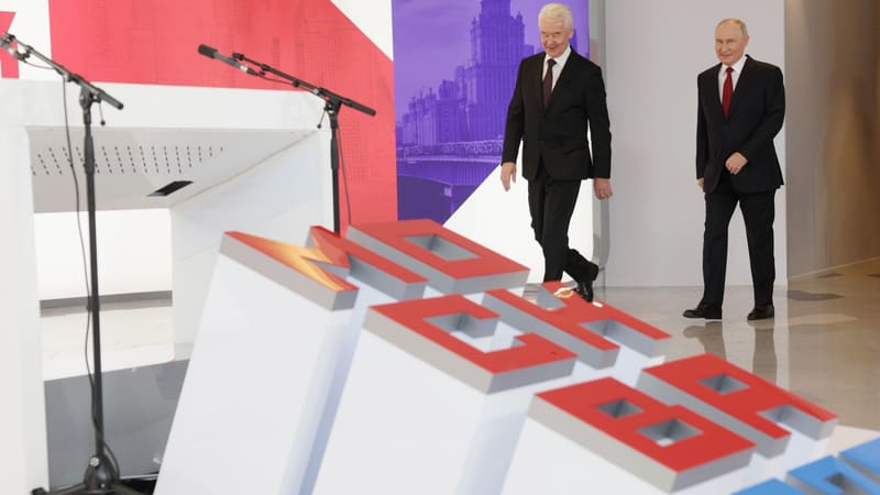 Moscow Mayor Sergei Sobyanin and Vladimir Putin walk past a lectern at a Moscow infrastructure ceremony