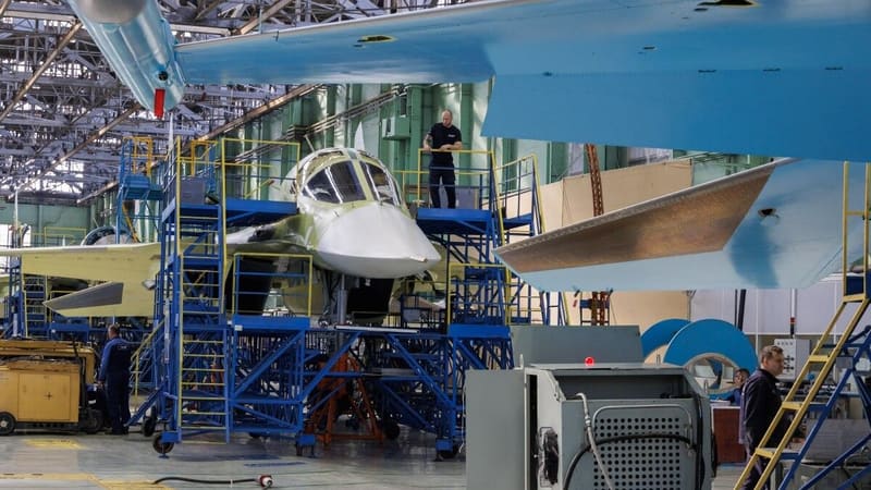 Su-34 airframes on work stands inside a large aircraft assembly hall