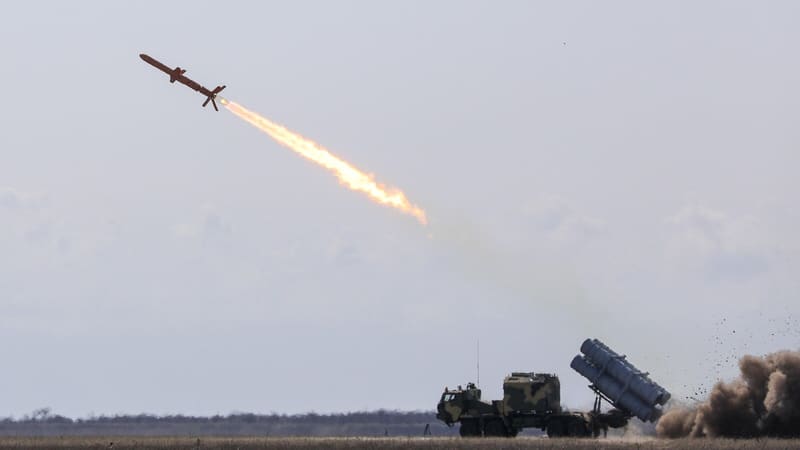A Neptune cruise missile climbs away from a truck-mounted launcher on open steppe
