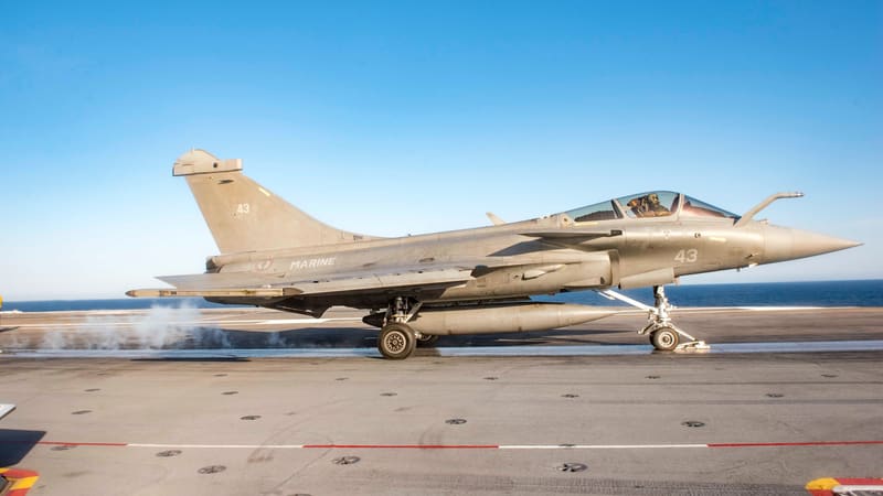 French Navy Rafale Marine fighter number 43 on the catapult of a U.S. aircraft carrier under a clear sky