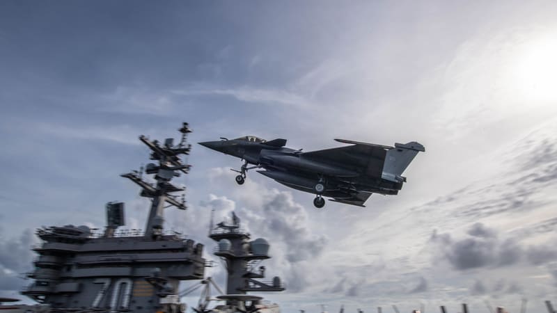 French Navy Rafale Marine fighter with landing gear down approaching the deck of a U.S. aircraft carrier