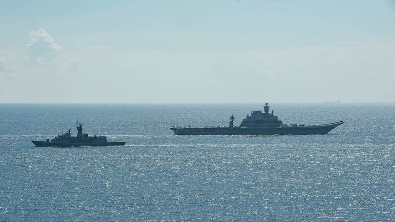 Indian aircraft carrier INS Vikramaditya sailing beside an Australian frigate in the Indian Ocean