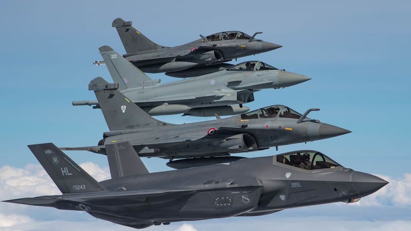 Two French Rafales and an RAF Eurofighter Typhoon flying in formation with a US F-35A above clouds over France