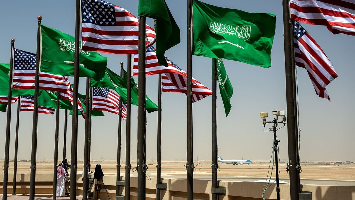 Saudi and US flags at Riyadh's King Khalid International Airport, a large Saudi flag in front, Air Force One on the runway