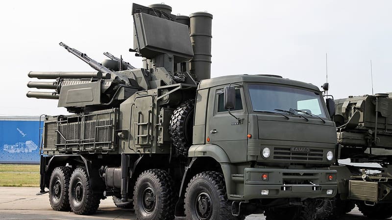 Green Pantsir-S1 air defence vehicle on a KamAZ truck with twin cannons and missile tubes, parked on concrete