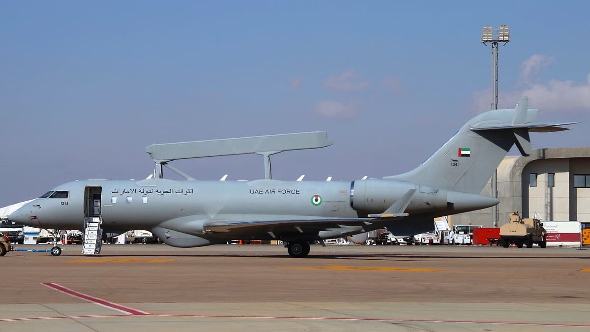 UAE Air Force GlobalEye jet with a long radar on its back parked on an airfield apron, seen in full side profile