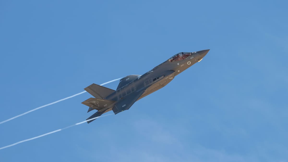 An Israeli Air Force F-35I Adir climbs steeply after takeoff, trailing vapour against a blue sky