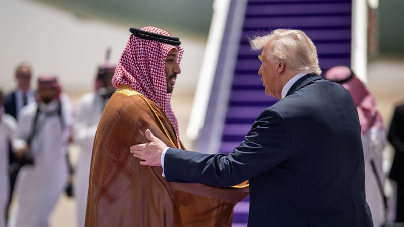 Donald Trump rests a hand on Crown Prince Mohammed bin Salman's arm beside the purple-carpeted stairs of Air Force One