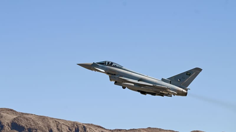 A grey Royal Saudi Air Force Eurofighter Typhoon climbs after takeoff against a clear blue sky