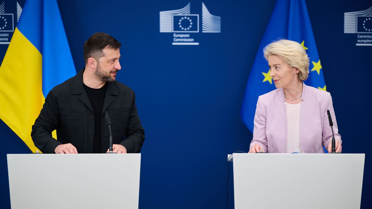 Zelensky and von der Leyen at white lecterns before Ukrainian and EU flags