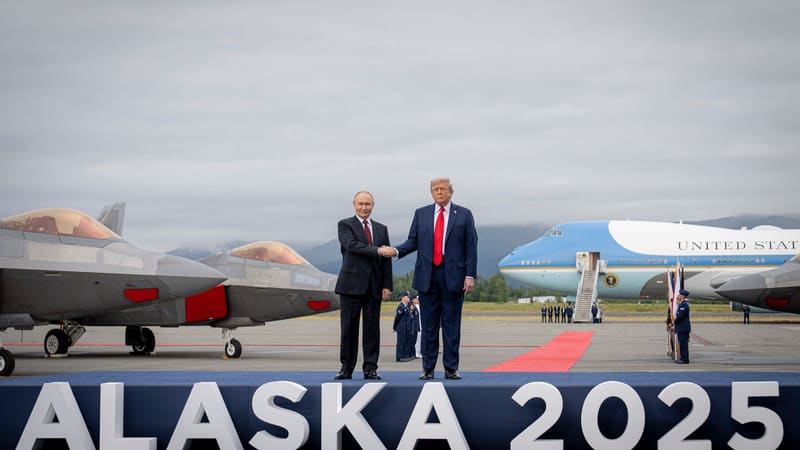 Trump and Putin shake hands on an Alaska airfield beside fighter jets and Air Force One