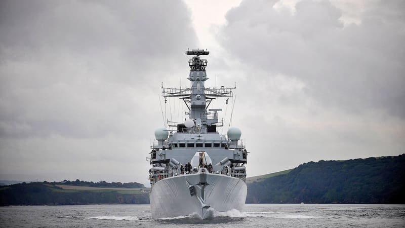 Royal Navy Type 23 frigate HMS Somerset sailing bow-on through Plymouth Sound under a grey sky