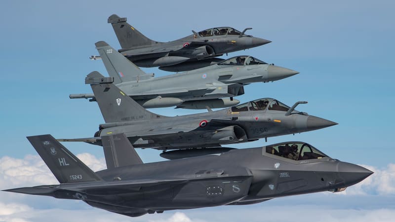 From top, a two-seat French Rafale B, an RAF Typhoon, a second Rafale and a U.S. F-35A flying in a tight stacked formation