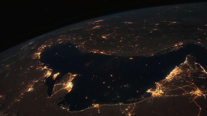 City lights and roads around the Persian Gulf at night from orbit