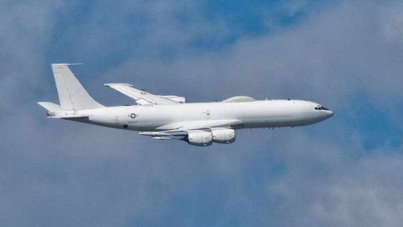 U.S. Navy E-6B Mercury aircraft in flight against a cloudy blue sky