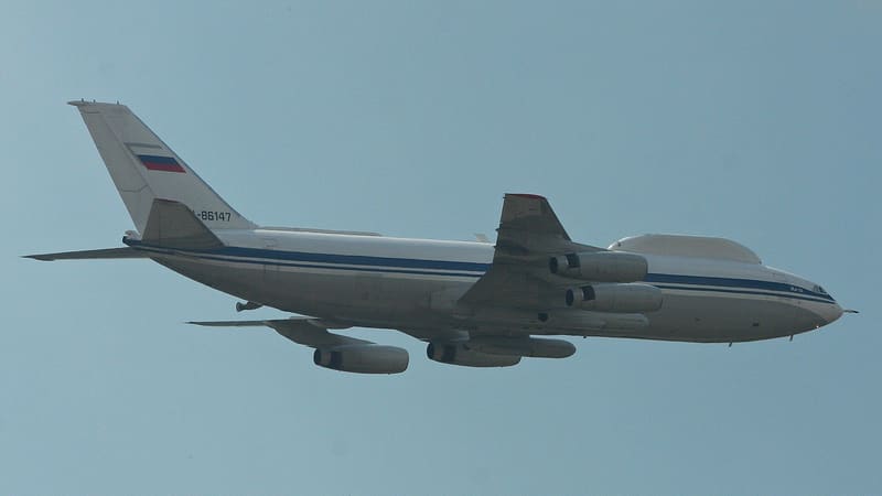 Russian Il-80 seen from below, with no cabin windows and a large fairing atop its forward fuselage