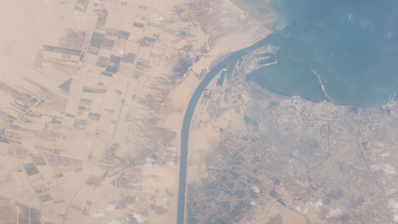 The Suez Canal meeting the Gulf of Suez beside the city of Suez, seen from orbit