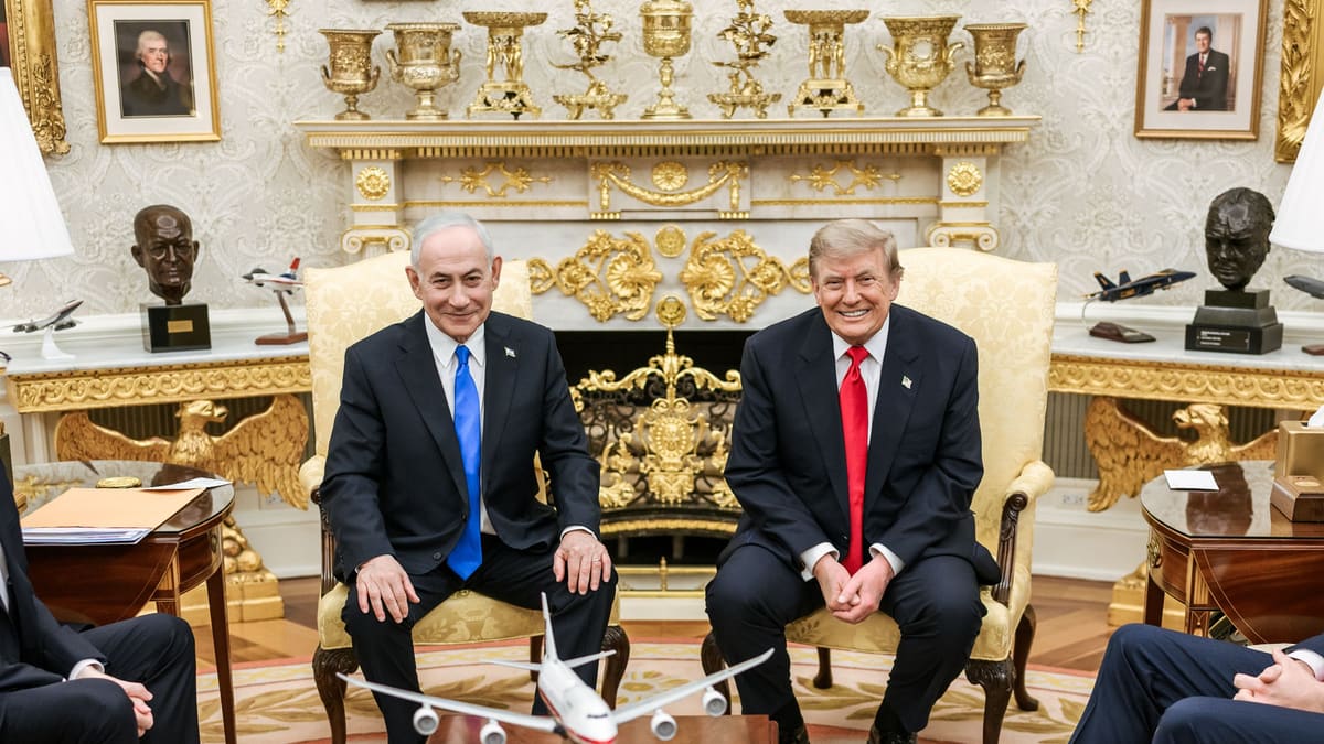 Benjamin Netanyahu and Donald Trump seated side by side before the Oval Office fireplace, a model airliner in front
